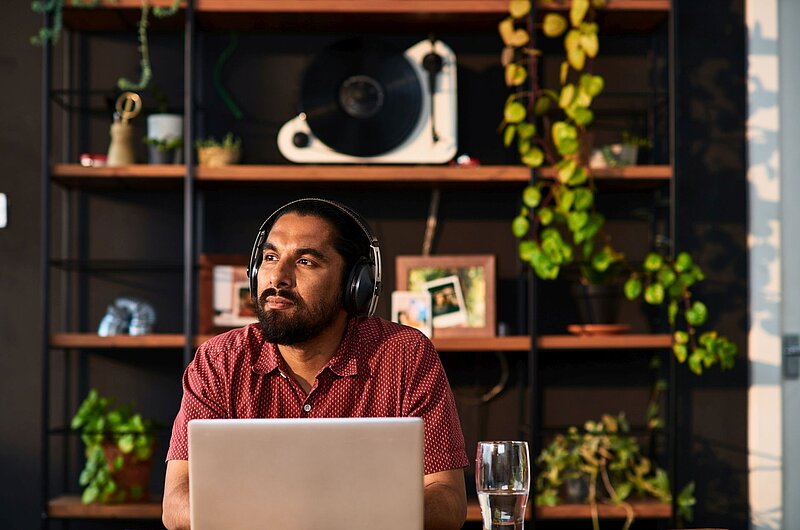 Lohnsteuerbescheinigung-10_000_Hours-Getty_Images Mann mit Kopfhörern am Schreibtisch