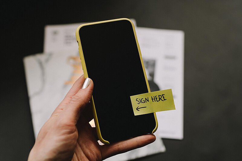 Steuererklaerung-2020-kelly-sikkema-unsplash Handy mit gelbem postet "Sign here"